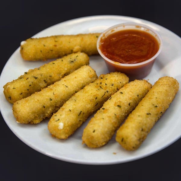 Six golden-brown mozzarella sticks with herbs on a white plate, served with a side of marinara sauce.