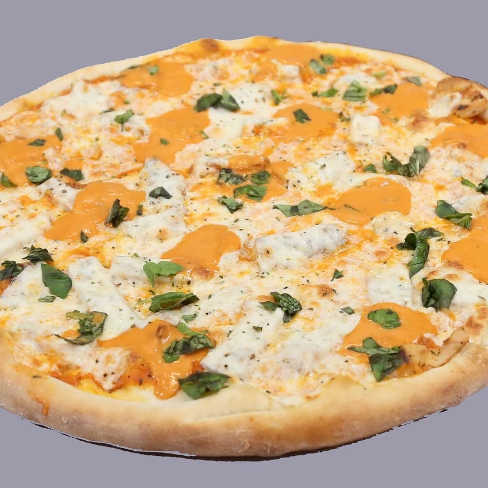 Mario's Pizza's vodka sauce pizza, topped with fresh mozzarella, creamy vodka sauce, and basil.